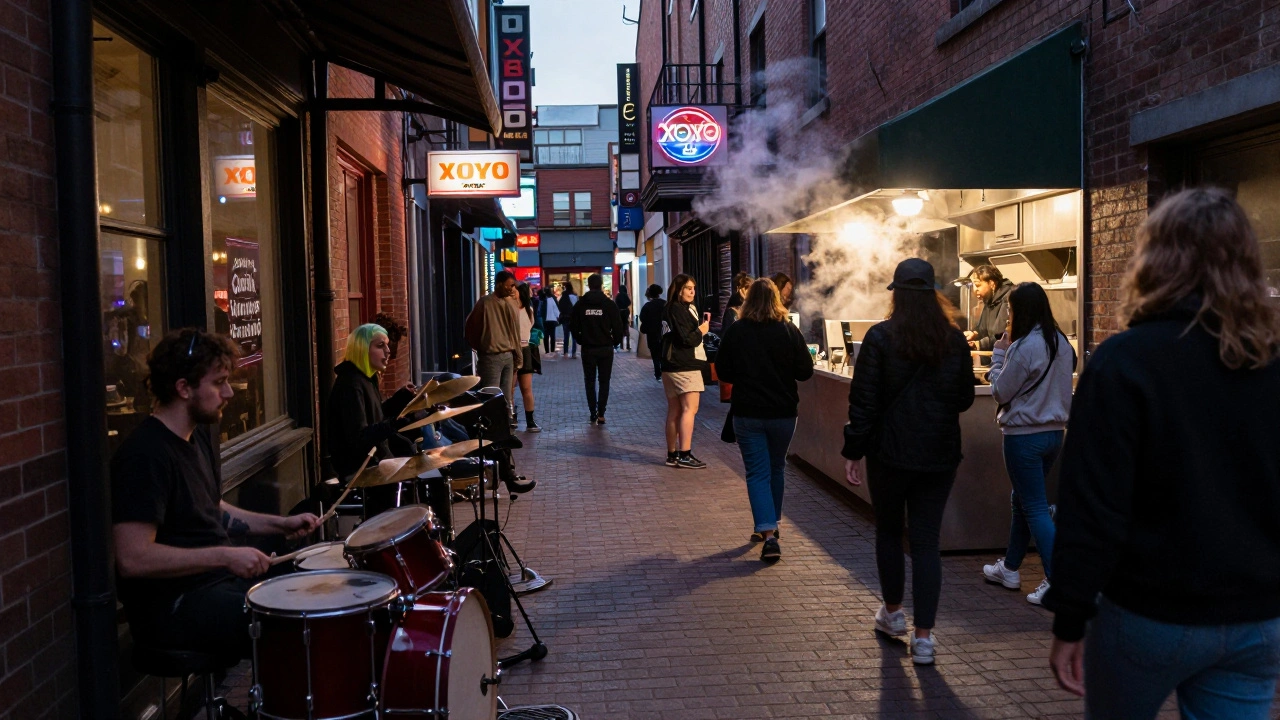 Long line of diverse patrons waits outside XOYO in Shoreditch alleyway at night.