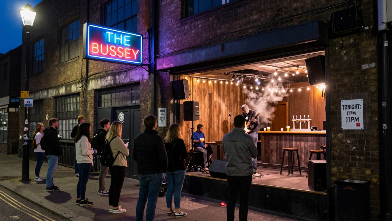 People waiting outside a warehouse venue with a hand-taped flyer on the wall.