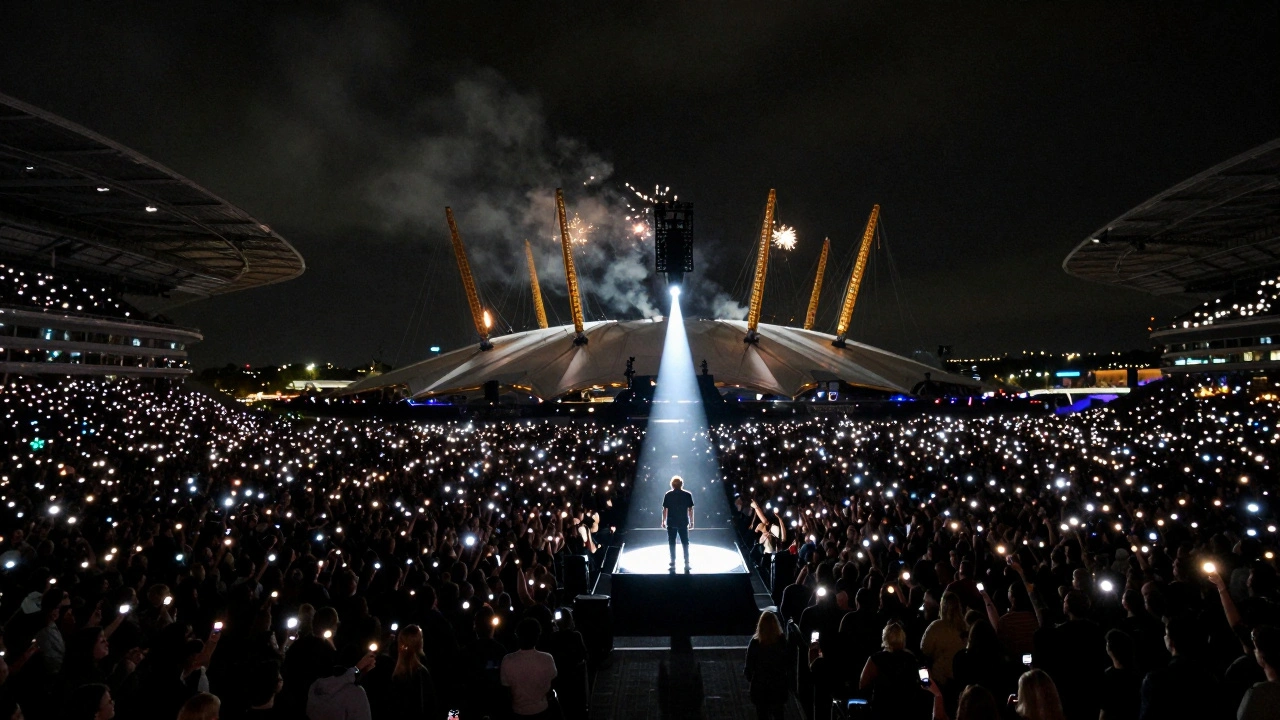 Thousands of people at O2 Arena holding phones, watching a singer under a spotlight.